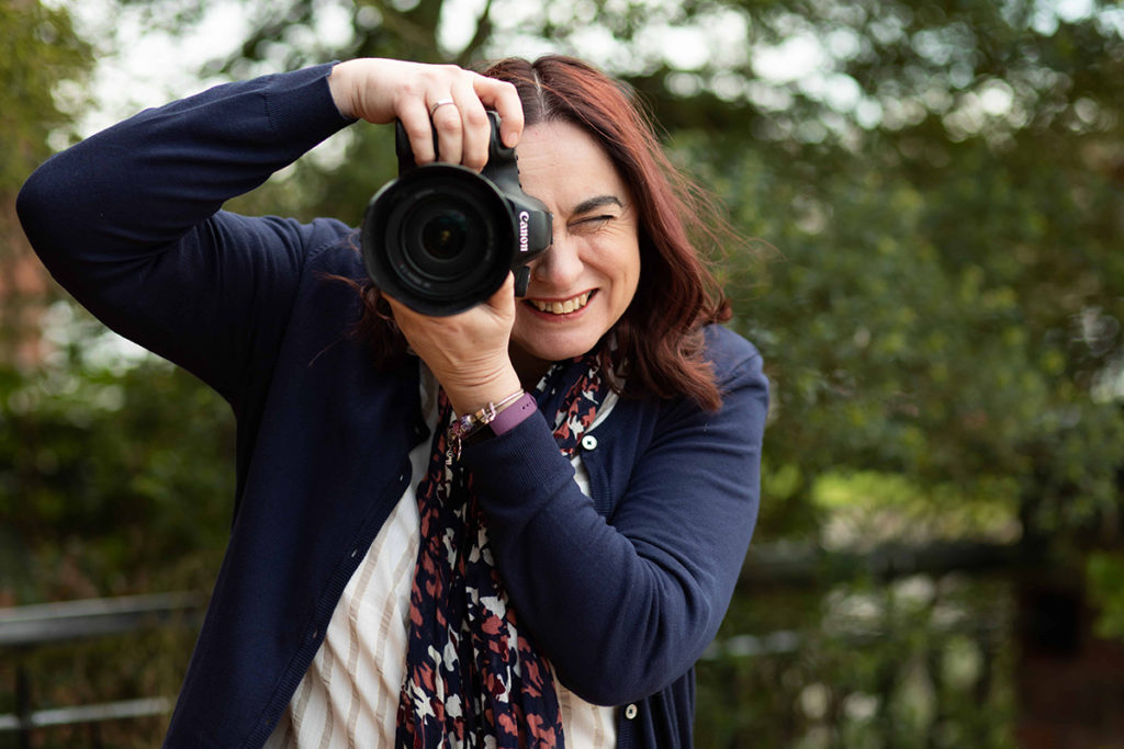 Woman holding camera to take a photo