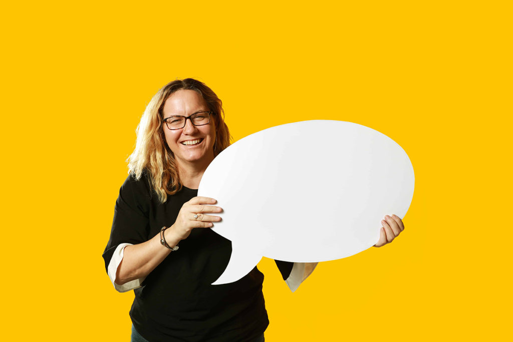 woman holding a giant speech bubble