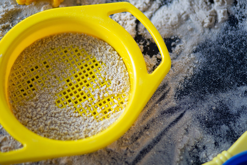 Close up of sieve in sand at a nursery