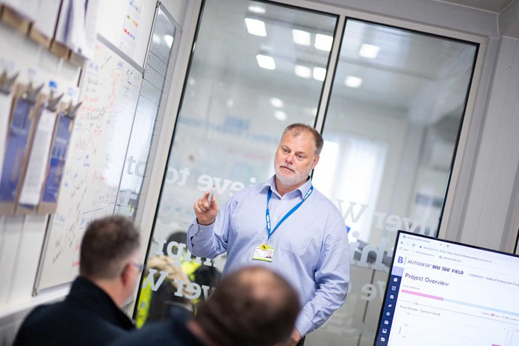 Men in office working on whiteboard in a meeting