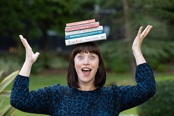 Woman balancing books