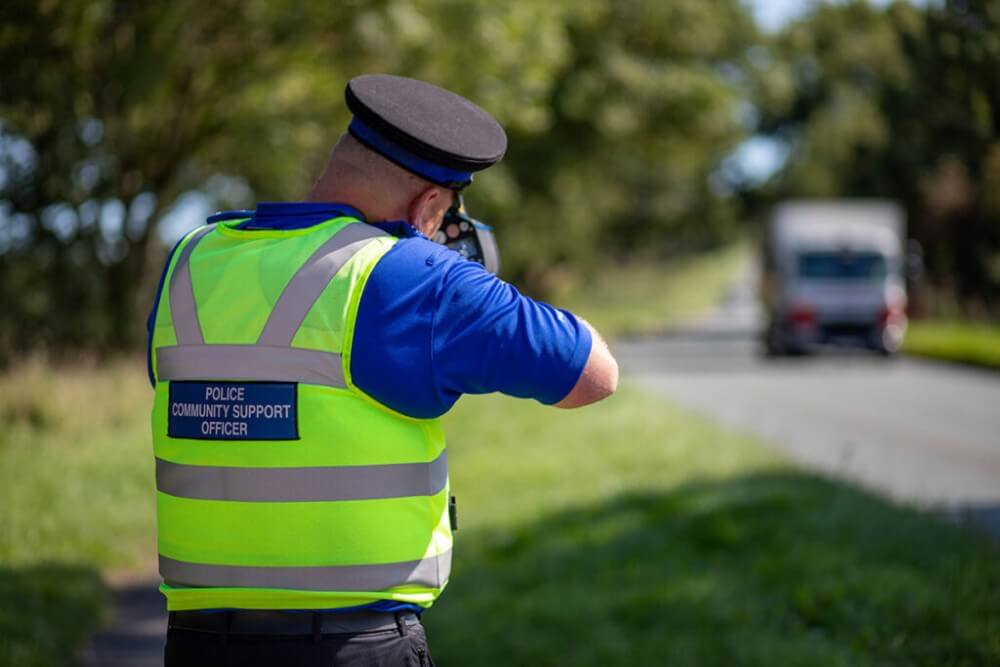 Commercial Photography - image of policeman in action with speed gun camera